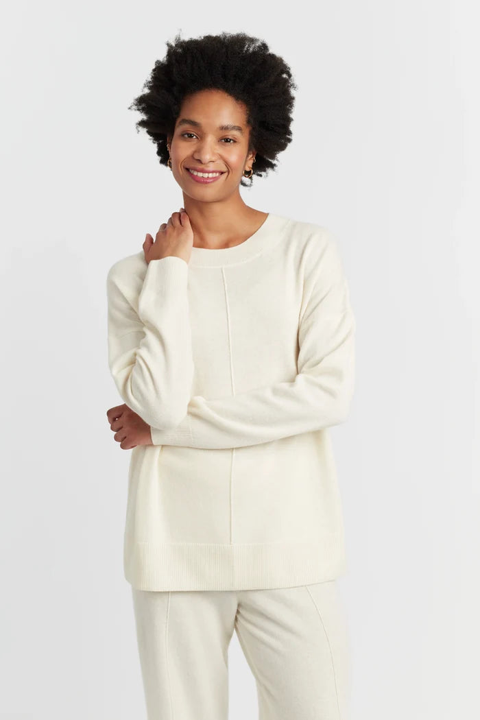 Person wearing a cream-colored outfit on a white background