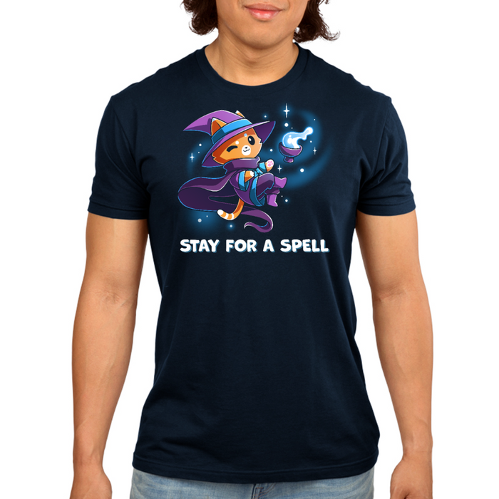 Premium Cotton T-shirt_TeeTurtle navy Stay For A Spell Premium Cotton T-shirt featuring an orange cat dressed as a witch, floating in space with a cauldron floating nearby. The cat is winking and the text at the bottom reads "Stay For A Spell"