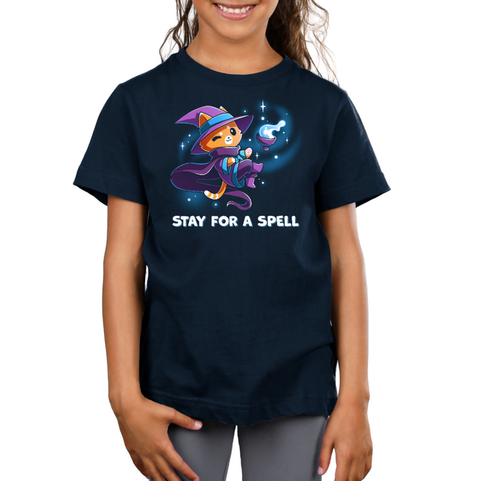 Premium Cotton T-shirt_TeeTurtle navy Stay For A Spell Premium Cotton T-shirt featuring an orange cat dressed as a witch, floating in space with a cauldron floating nearby. The cat is winking and the text at the bottom reads "Stay For A Spell"
