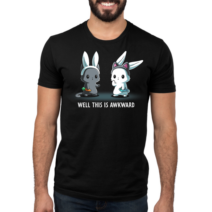 Premium Cotton T-shirt_TeeTurtle black Well This Is Awkward Premium Cotton T-shirt featuring a a cat in bunny ears holding a carrot and a bunny in cat ears holding a piece of fish. Both look unsettled. Text at the bottom reads "Well This Is Awkward"